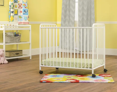 Vista 2 de Child Craft Siesta Cuna portátil compacta de metal no plegable con colchón de cuna de 2 pulgadas y ruedas de bloqueo, construcción de metal